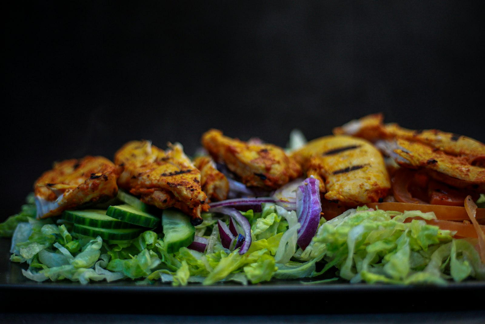 Greek marinated chicken breast over fresh salad