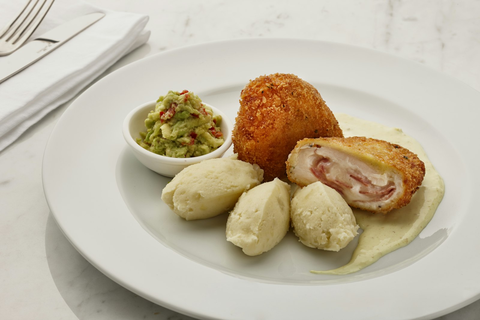 Chicken Kiev cut open with potatoes