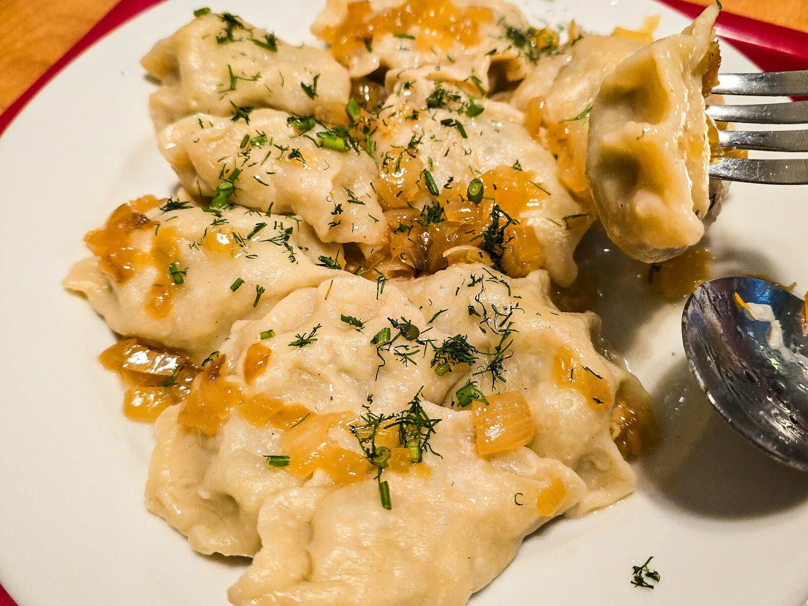 Eastern European pierogi topped with onions and herbs