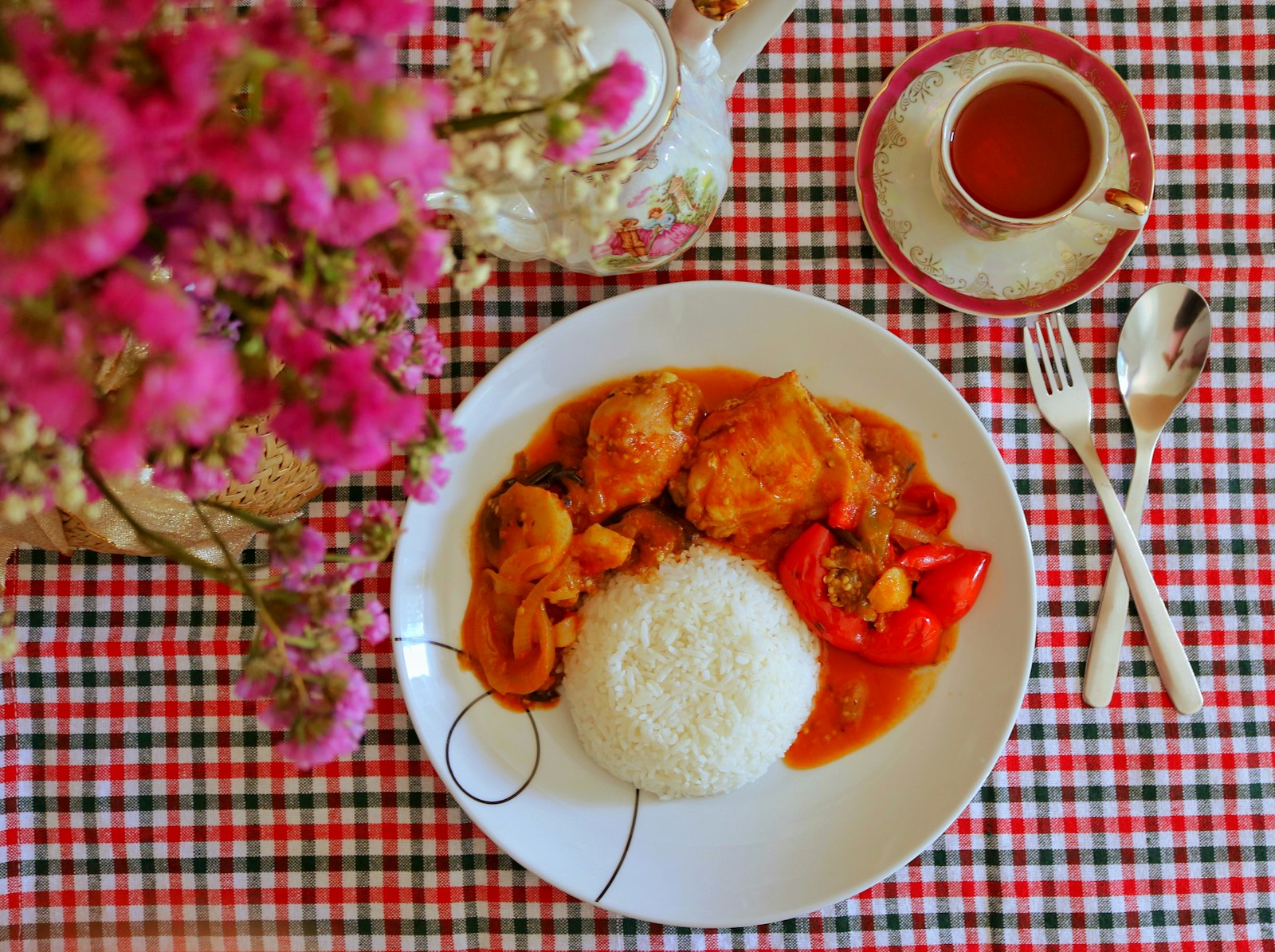 Filipino chicken afritada in tomato sauce with rice