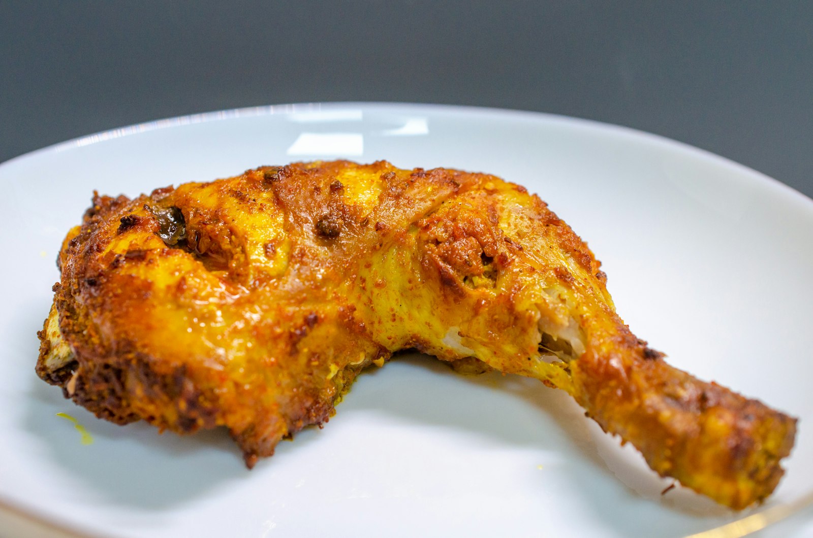 Grilled chicken leg with charred skin