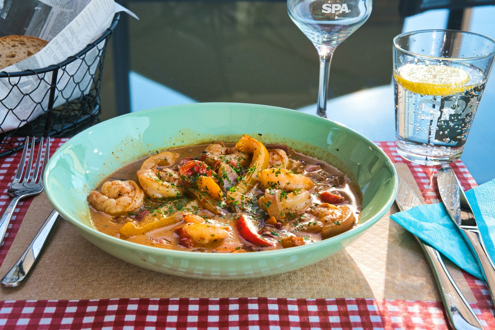 Creole style stew with peppers in a green bowl