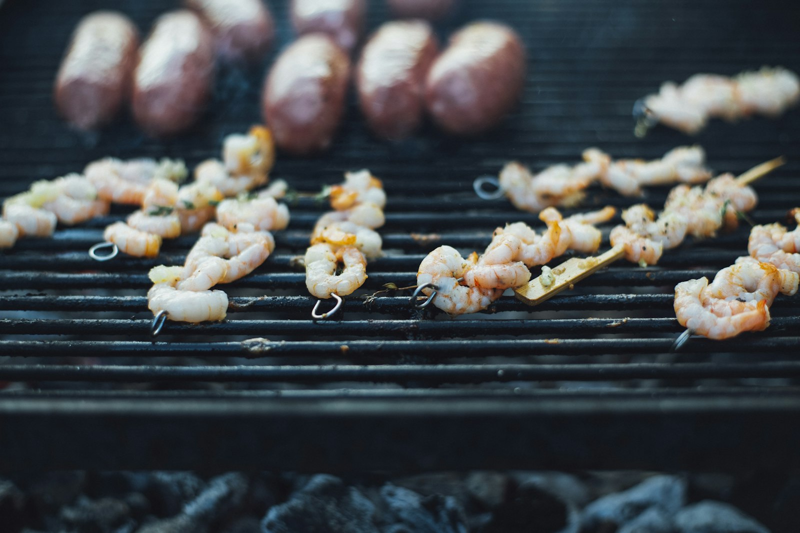 Grilled prawn skewers over hot coals