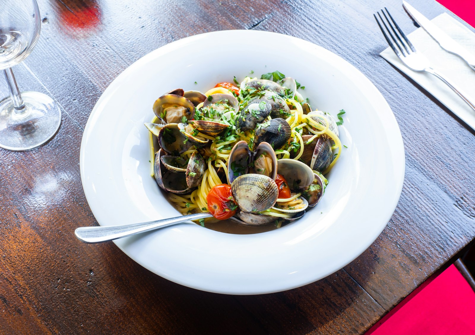 Linguine with clams in a white bowl