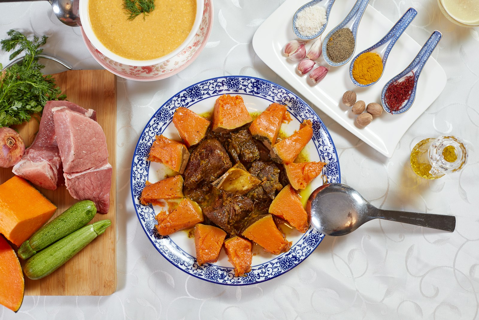 Beef tagine with carrots and potatoes on a blue plate