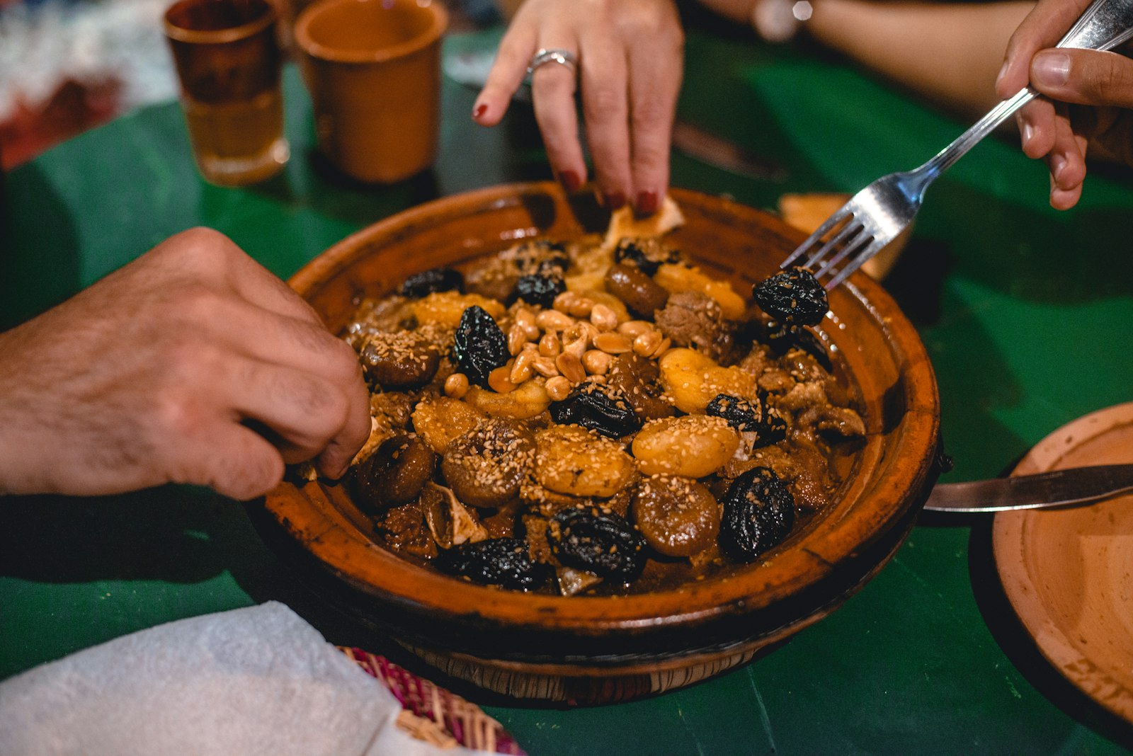 Tender lamb tagine with prunes served in a clay pot