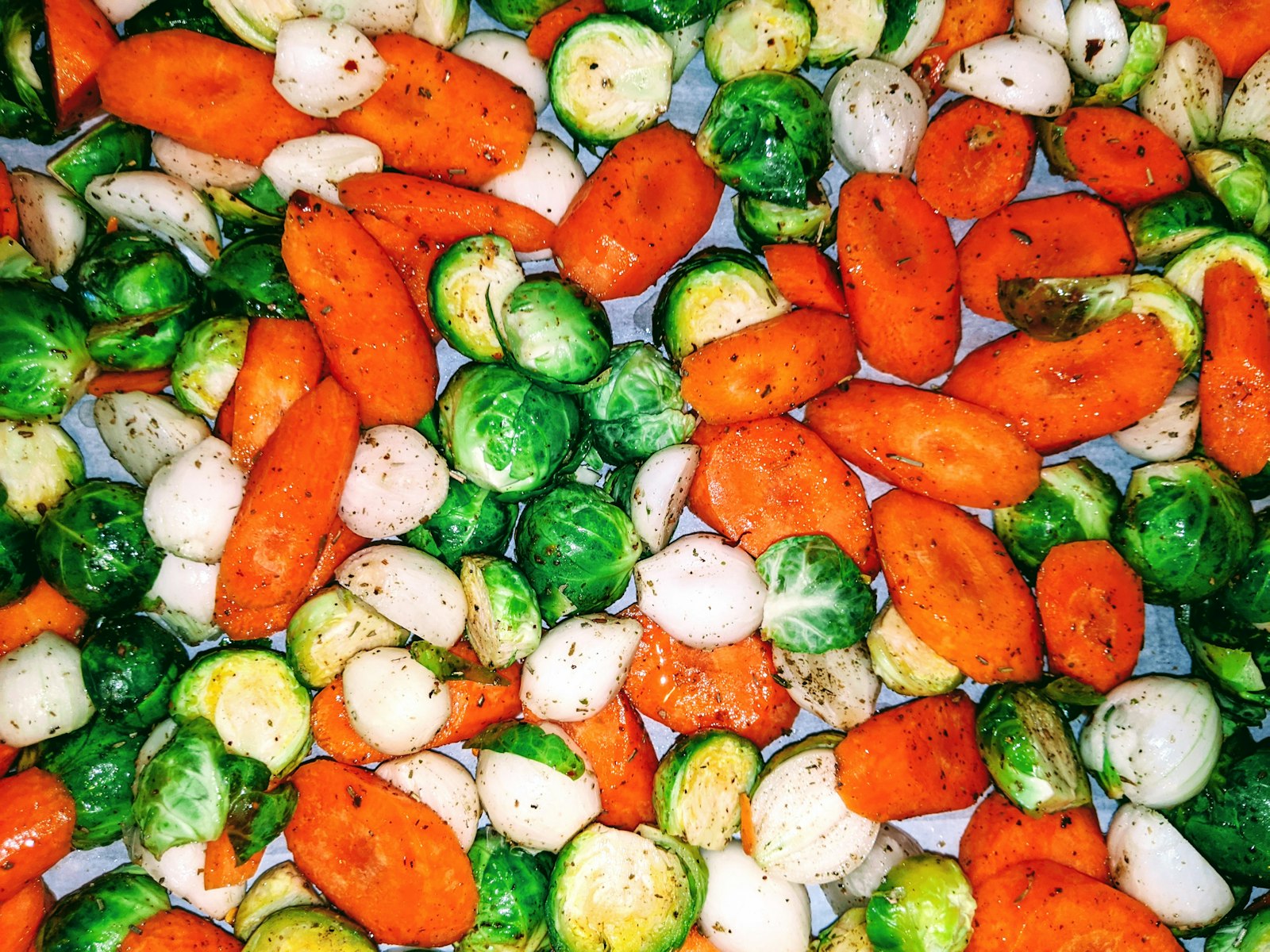 Colorful roasted carrots, Brussels sprouts and radishes for meatless sheet pan dinners