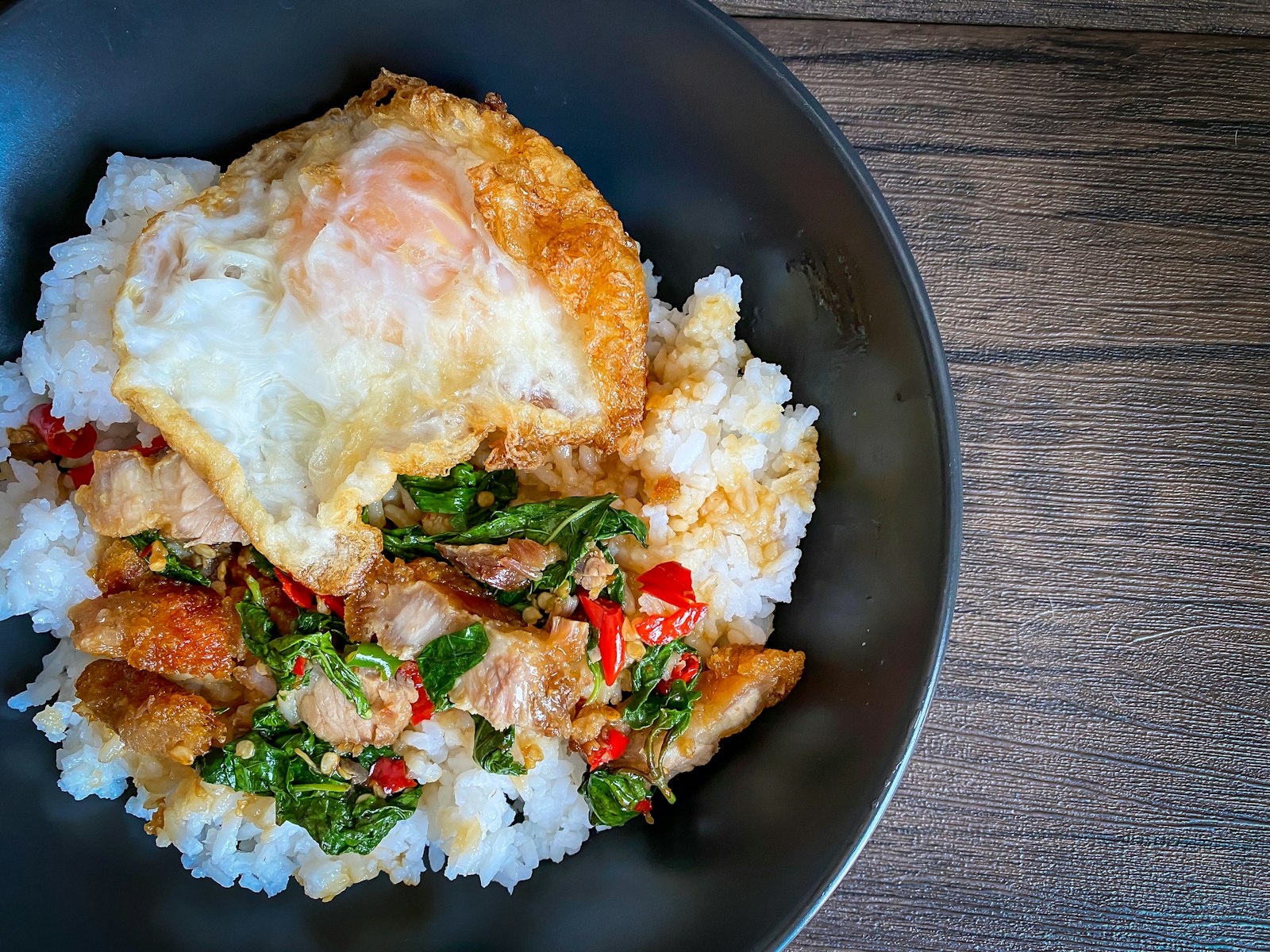 Thai basil chicken with rice and a fried egg