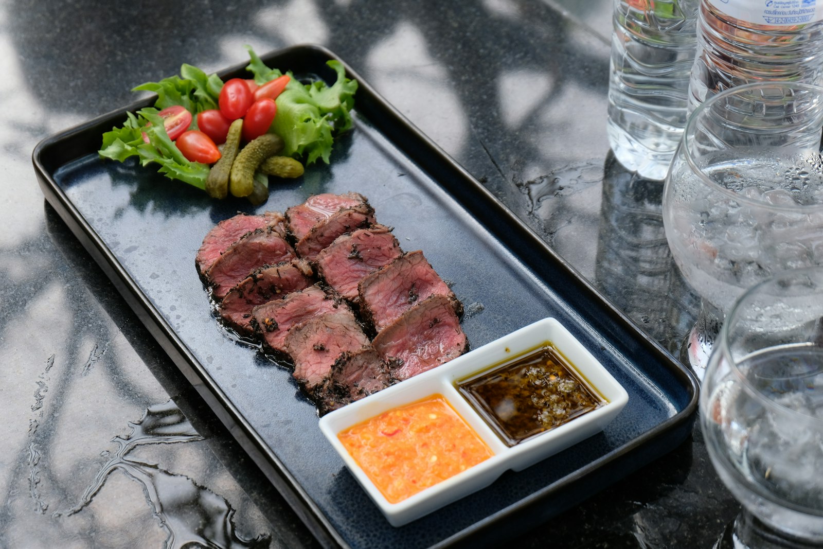 Sliced grilled steak with dipping sauce