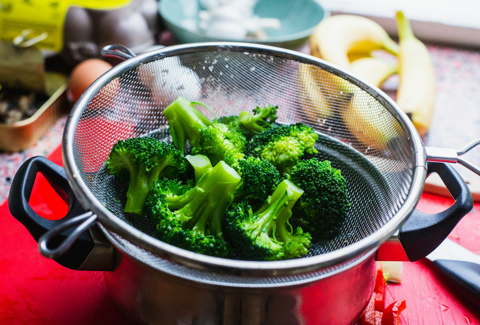 Bright green broccoli florets in a pan