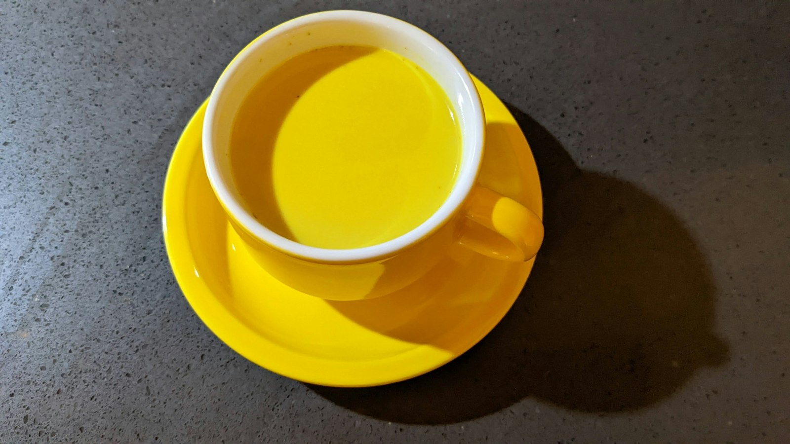 Golden turmeric milk in a yellow cup
