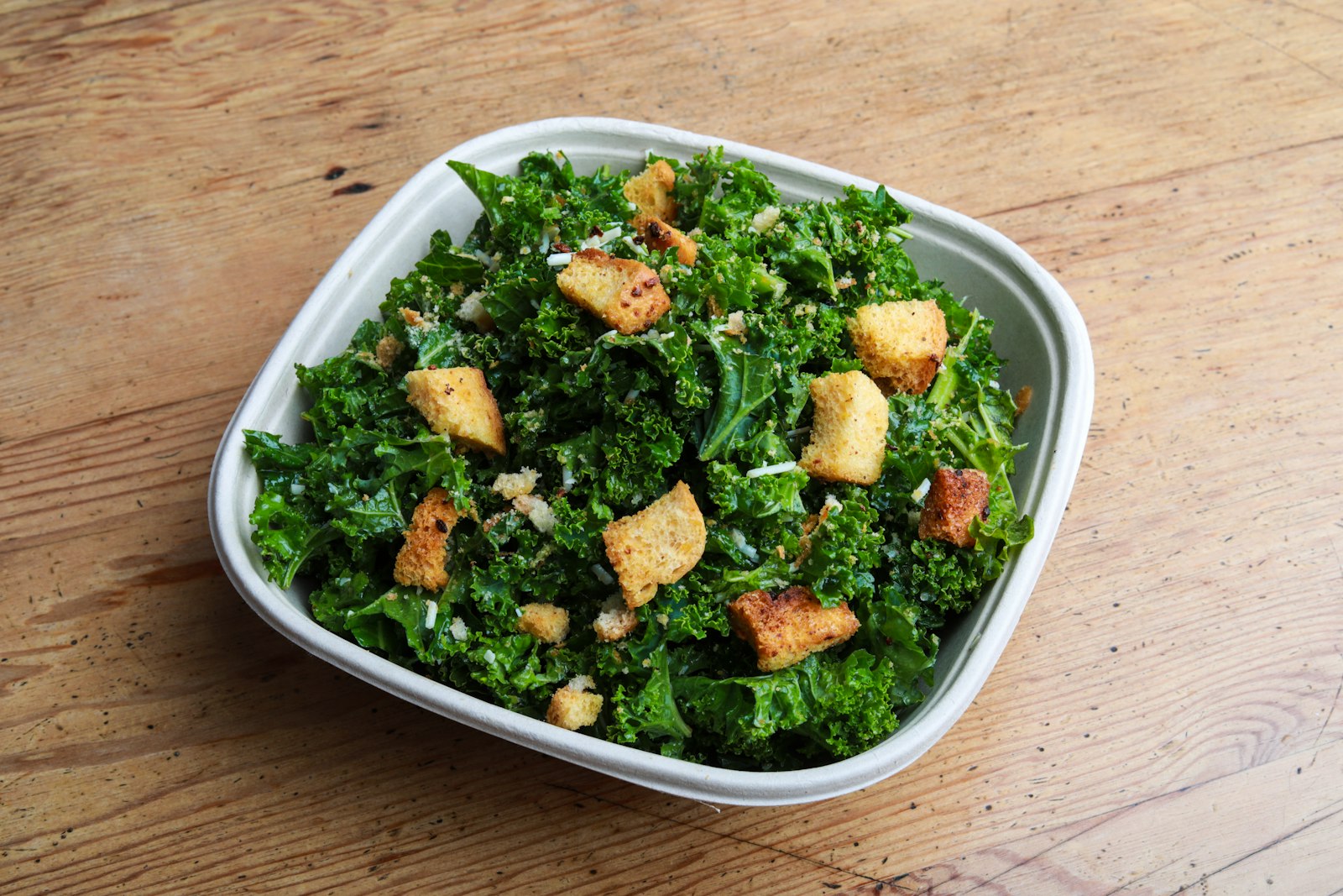 Anti-inflammatory foods: kale salad in a white bowl