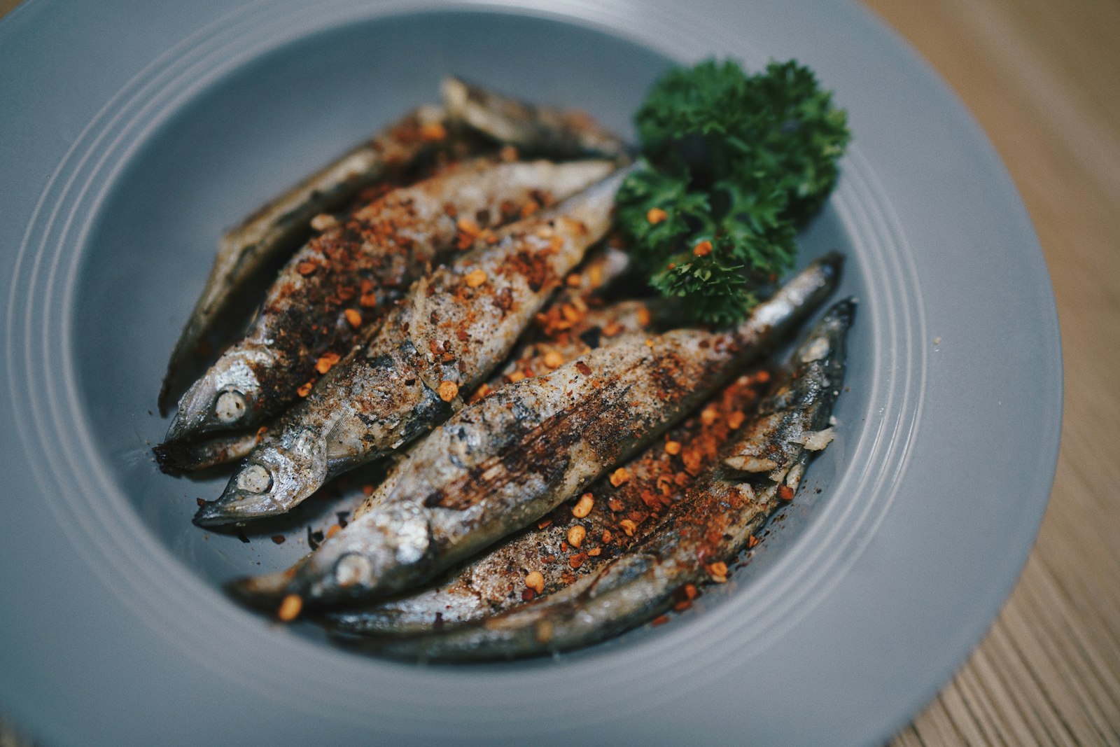 Grilled sardines on a white plate