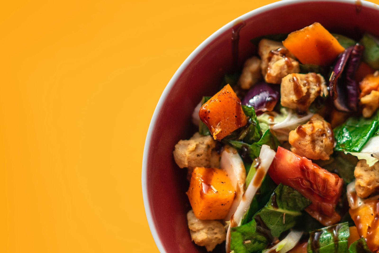 Roasted vegetables with tahini dressing in a colorful dish