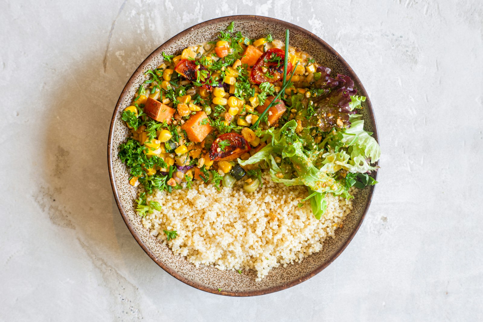Roasted sweet potato and chickpeas over quinoa with greens