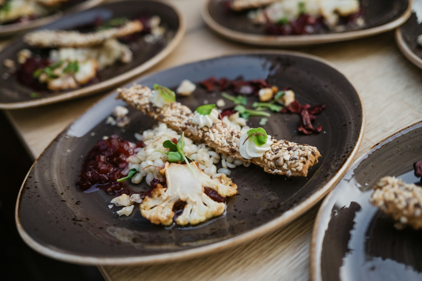 Cauliflower steak with herbs on a dark plate