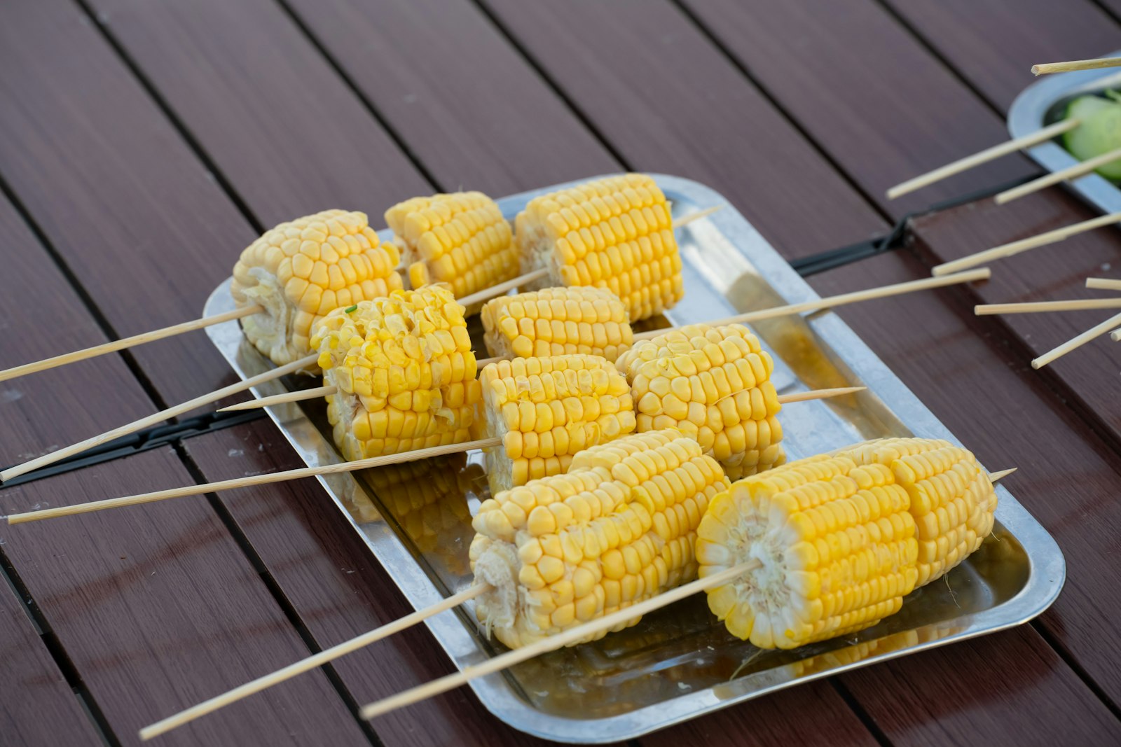 Skewers of grilled cobs on a tray