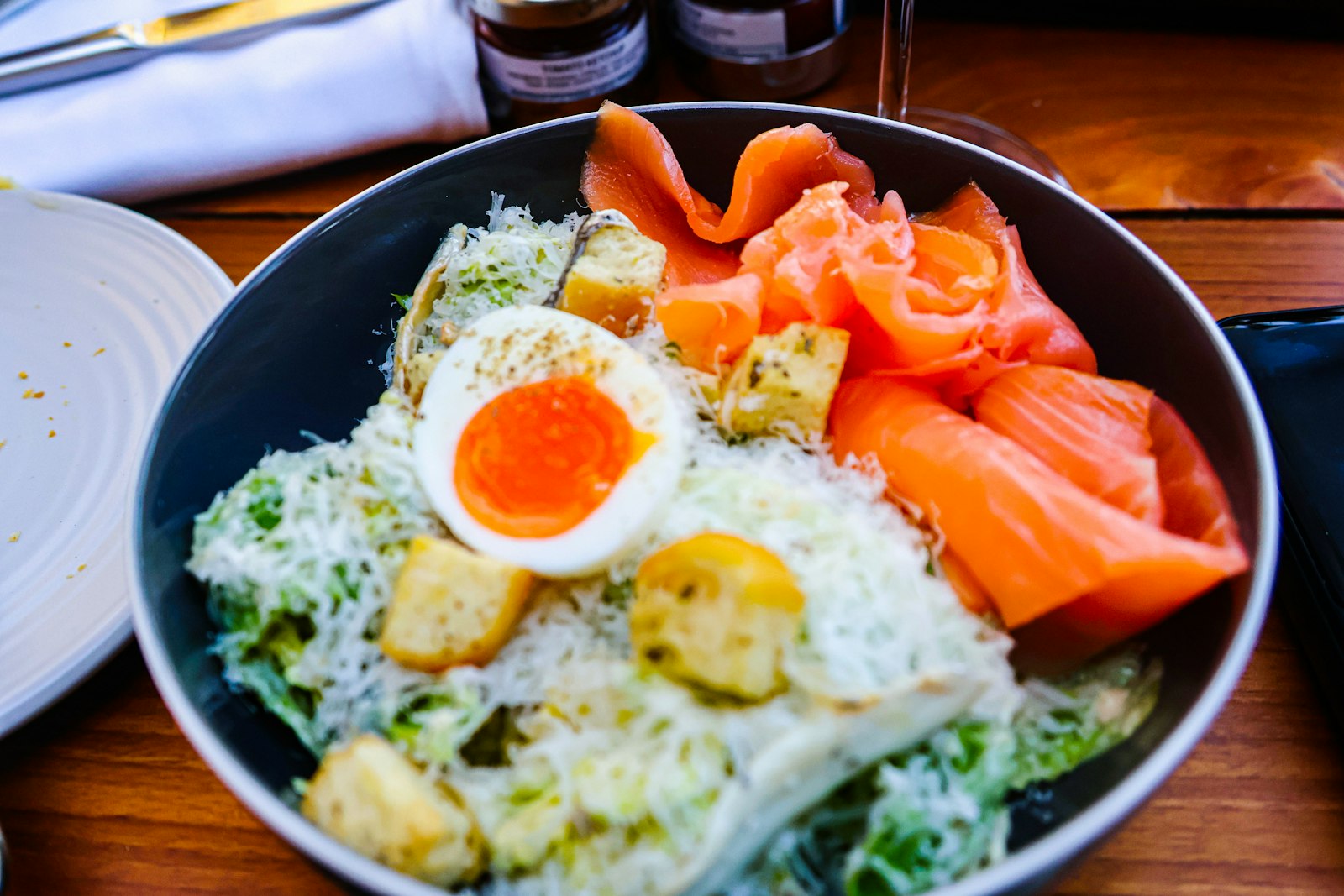 Smoked salmon Caesar salad with a soft boiled egg