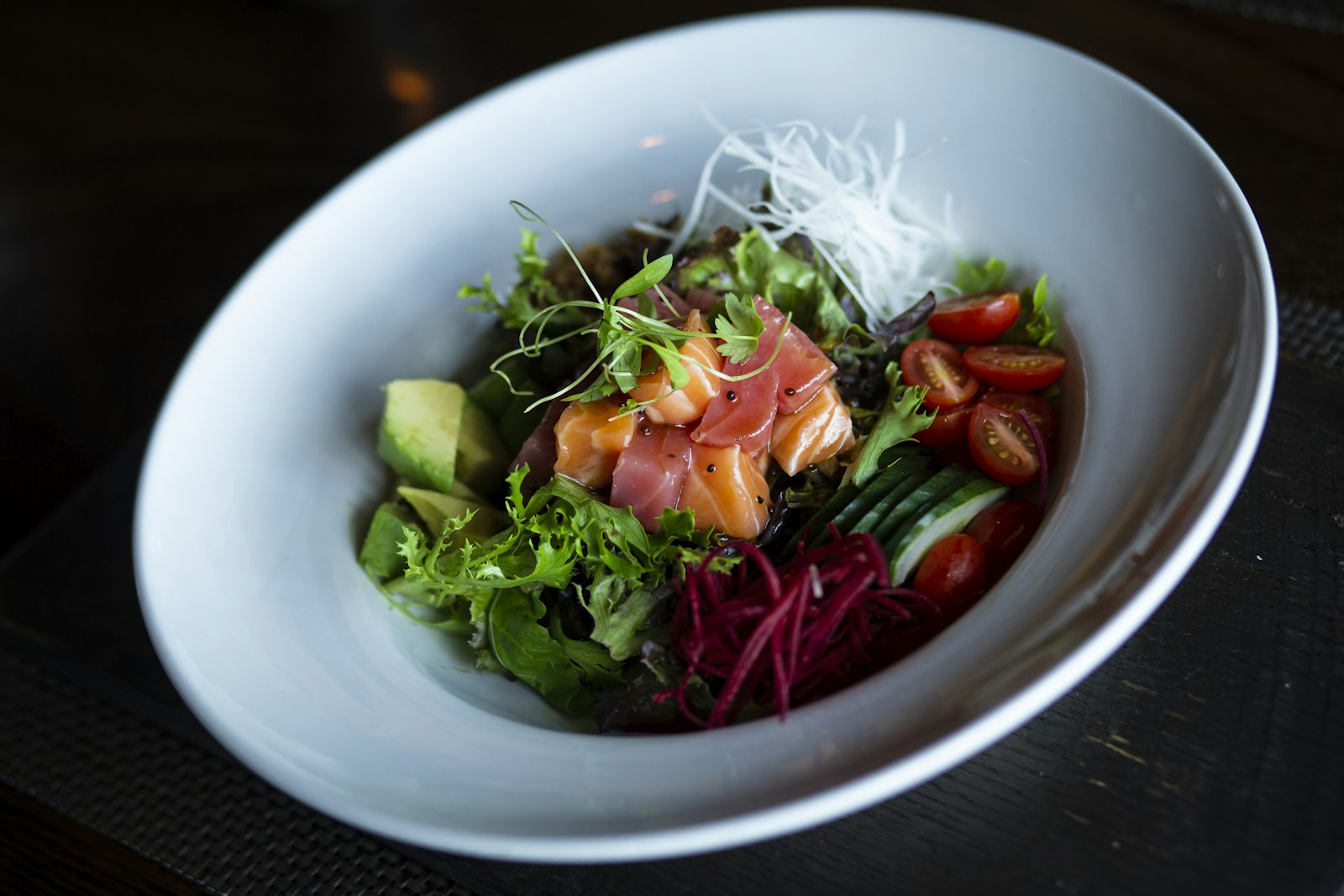 Salmon salad bowl with avocado, beets and greens