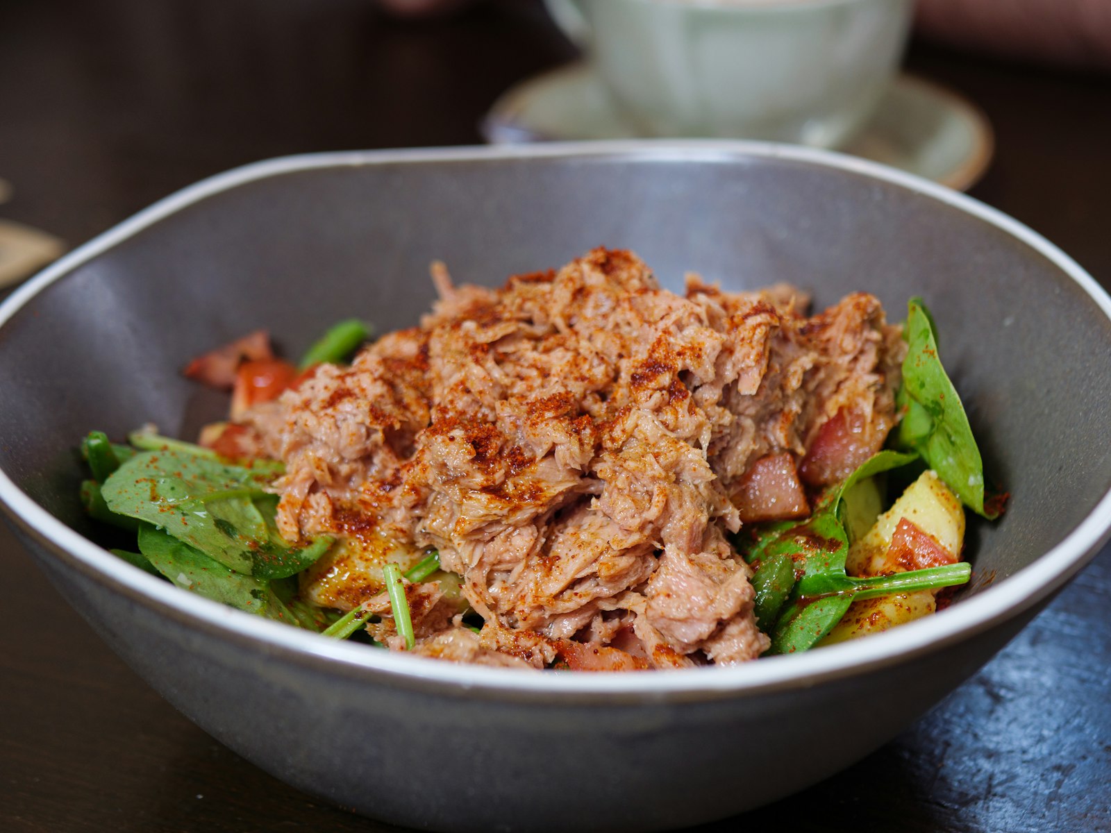 Tuna salad with spinach in a gray bowl