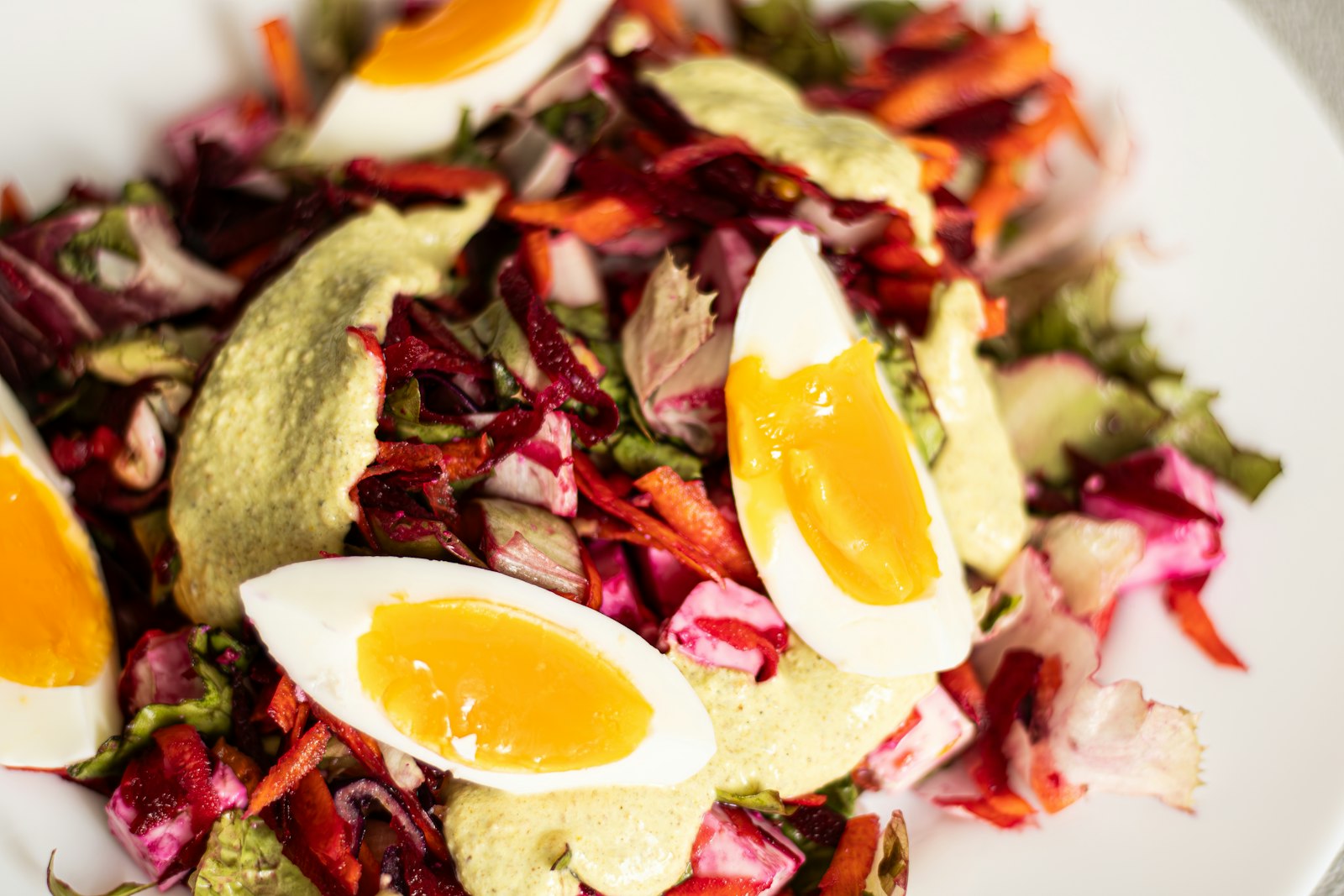 Boiled eggs and avocado over greens