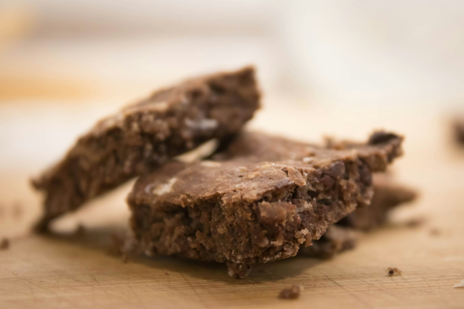 Chocolate oat bars stacked on a board