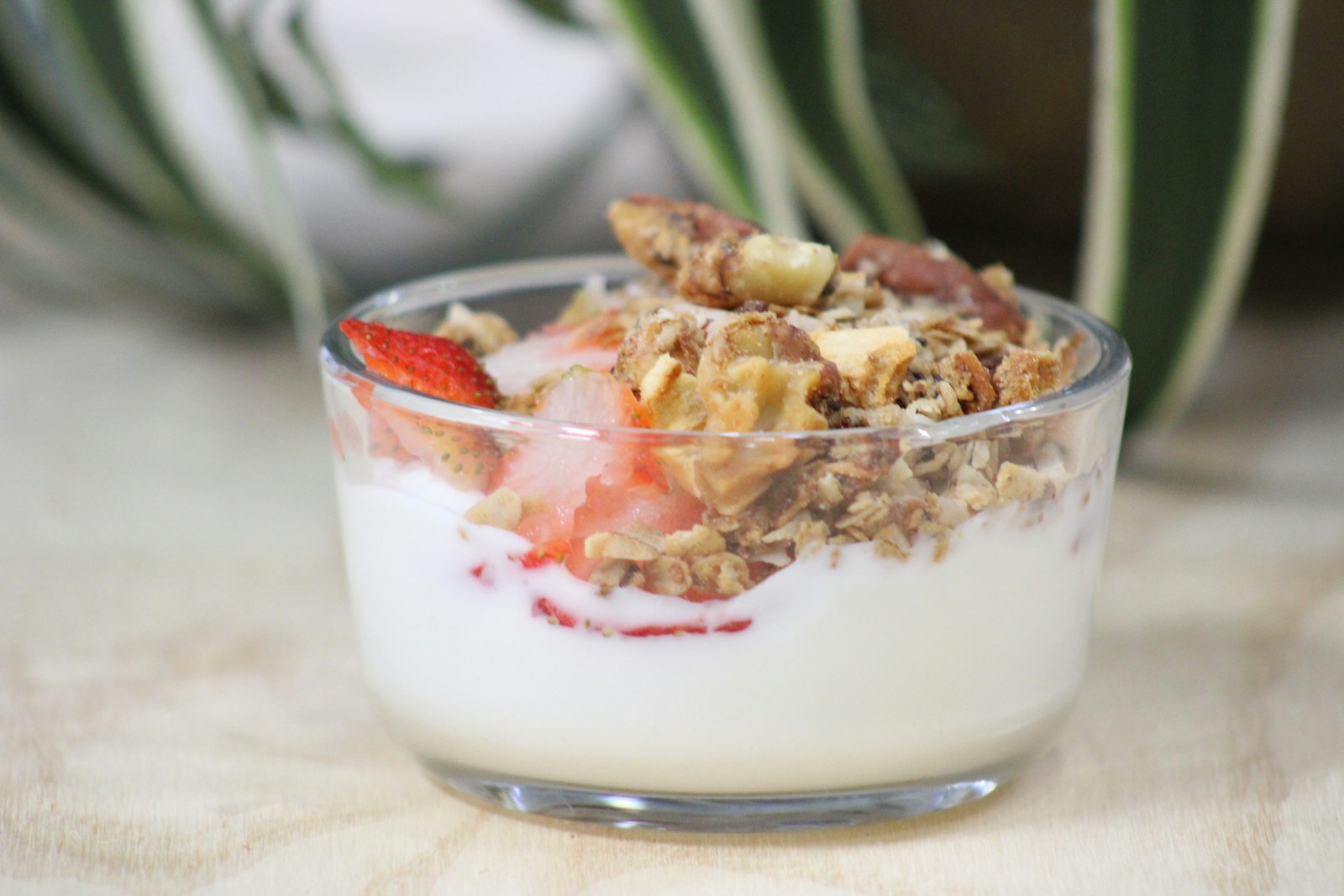 Greek yogurt topped with granola and strawberries