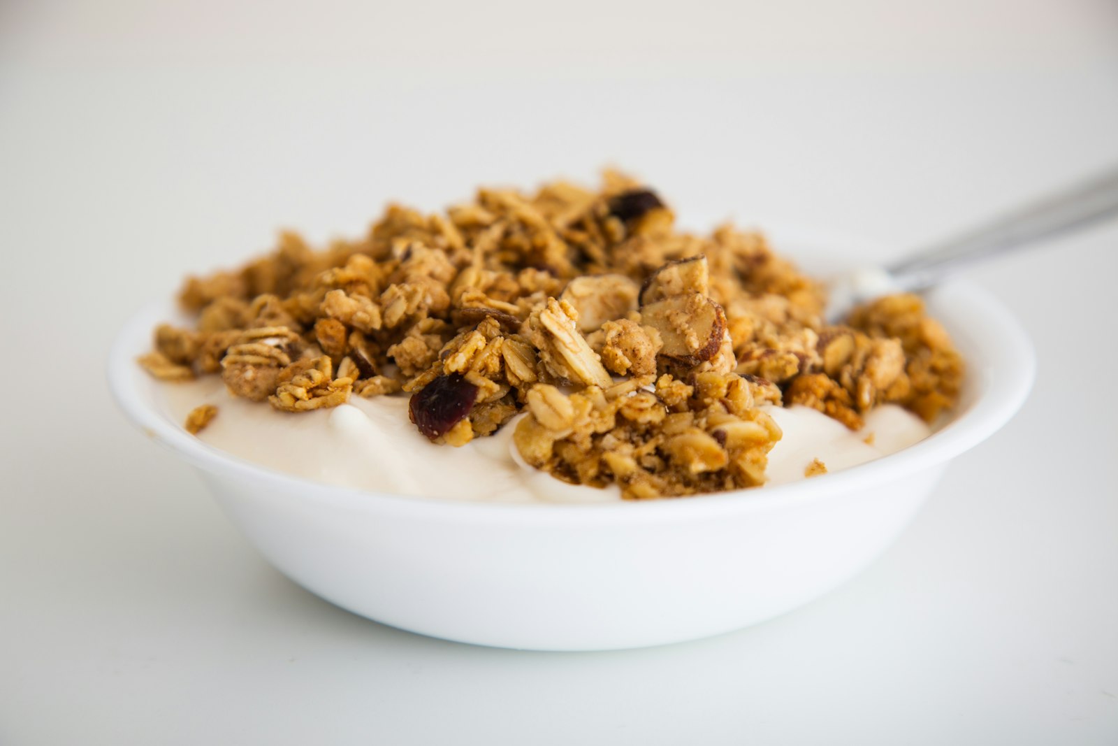 Granola with milk in a white bowl