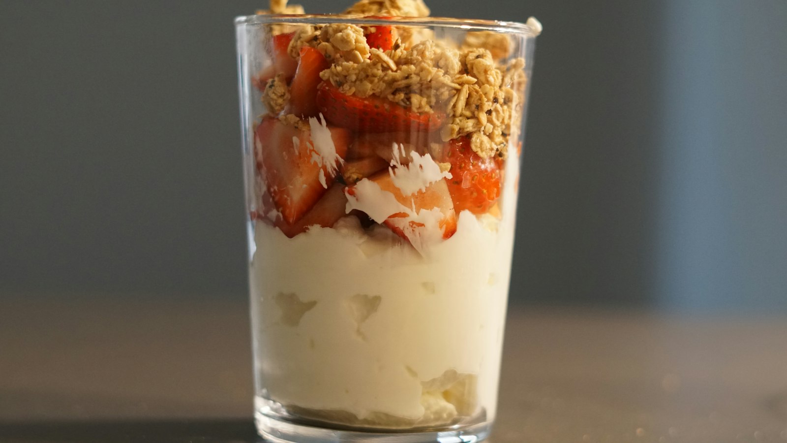 Layered yogurt parfait in a tall glass