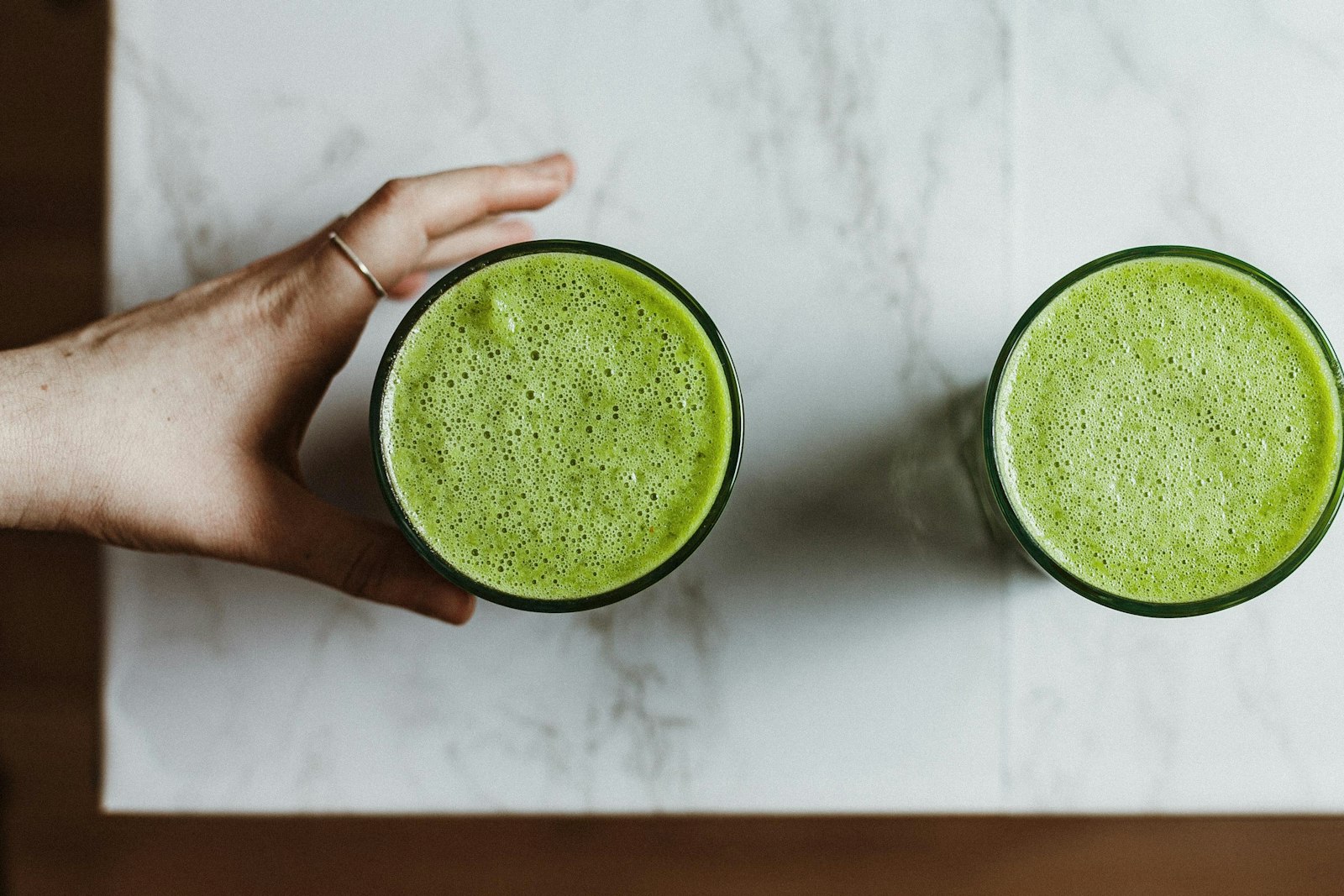 Green smoothie recipes: two glasses of spinach banana smoothie from above