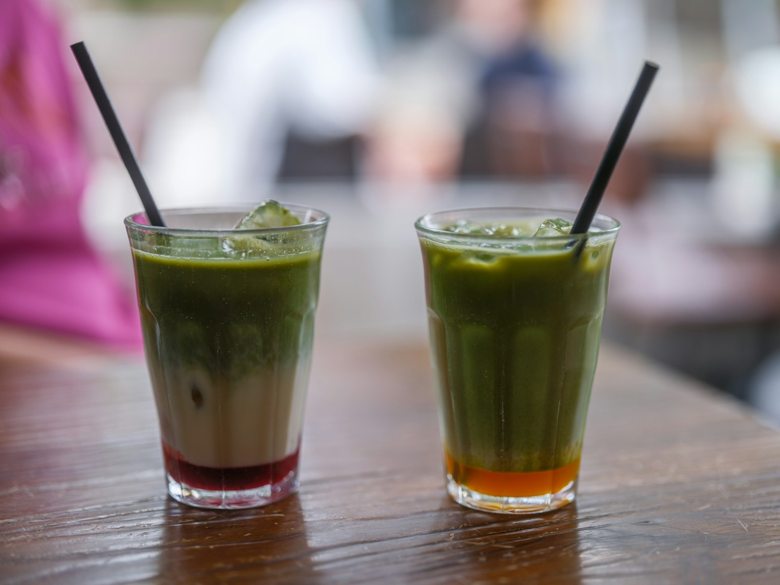 Two iced matcha banana drinks with straws