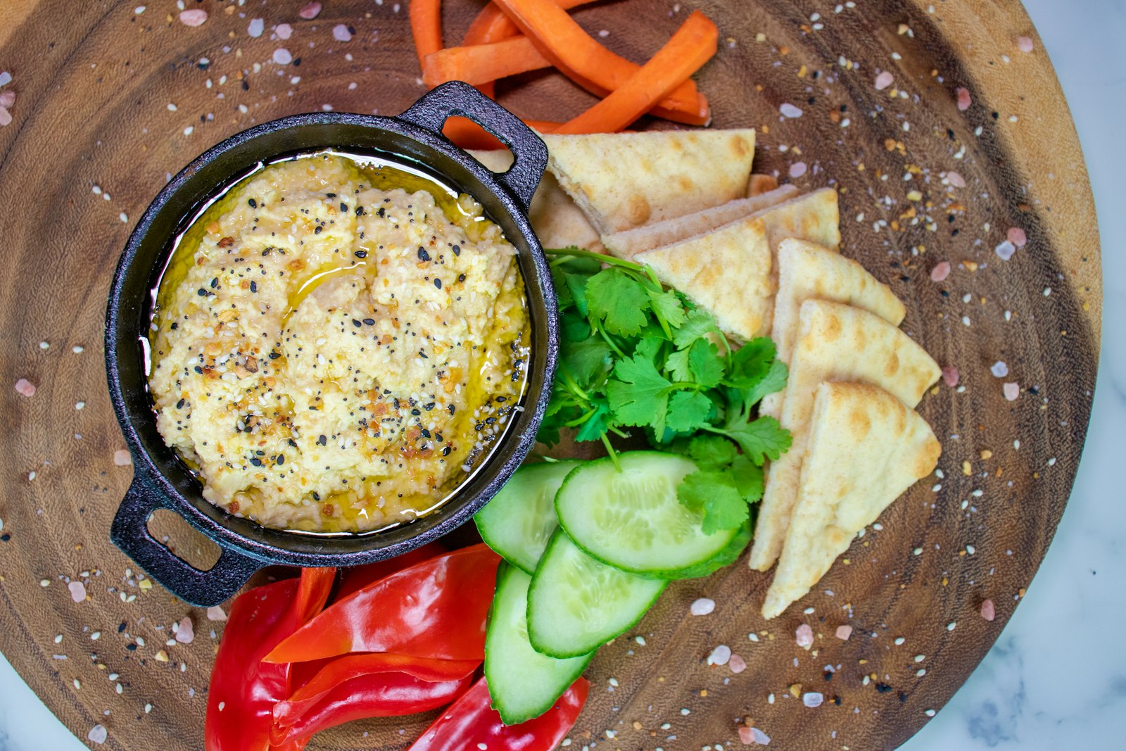 Hot crab dip in a skillet with bread and vegetables