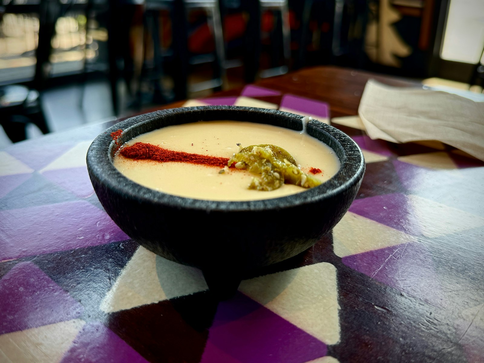 Warm queso dip in a stone bowl