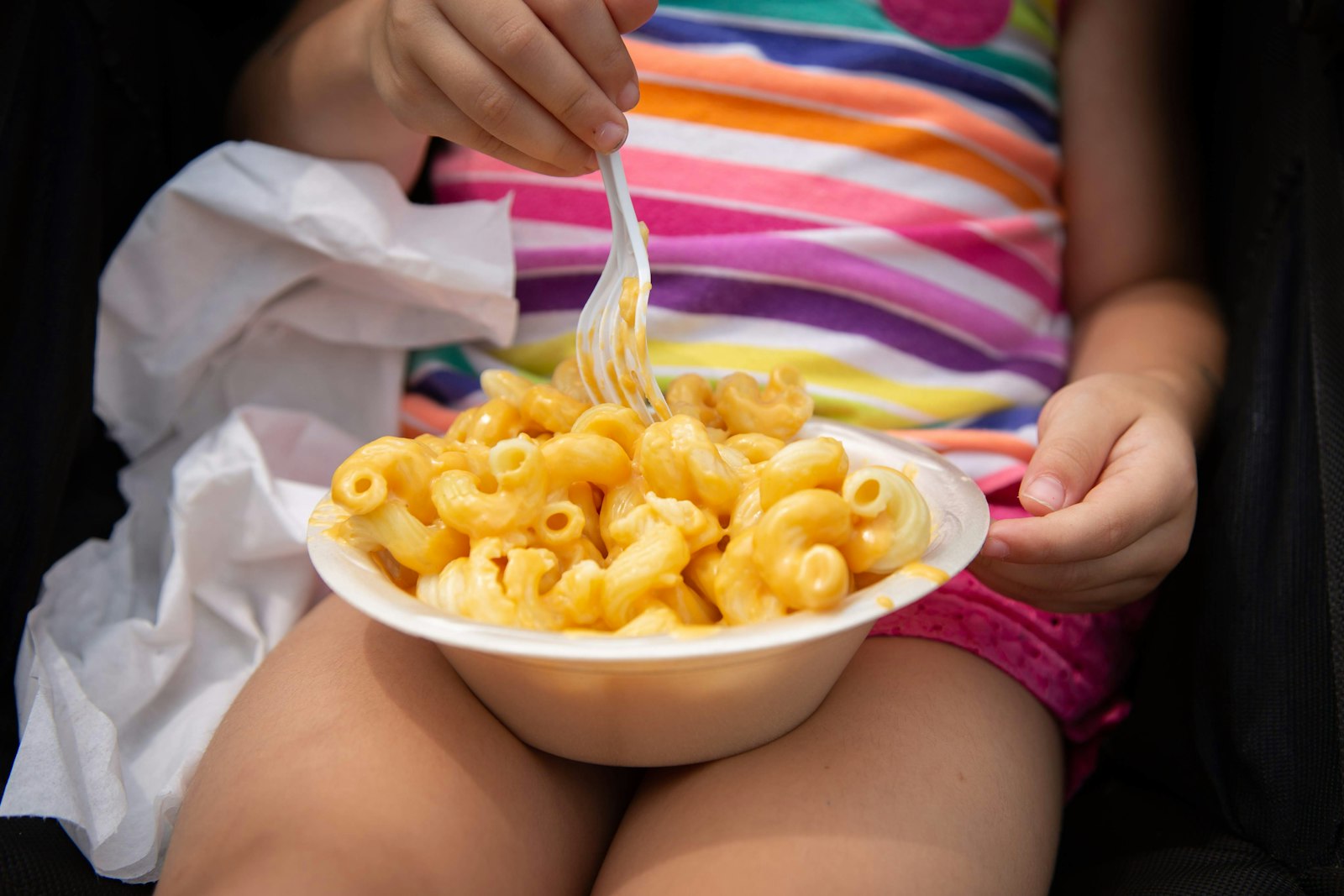 Hidden veggie recipes: child eating butternut mac and cheese