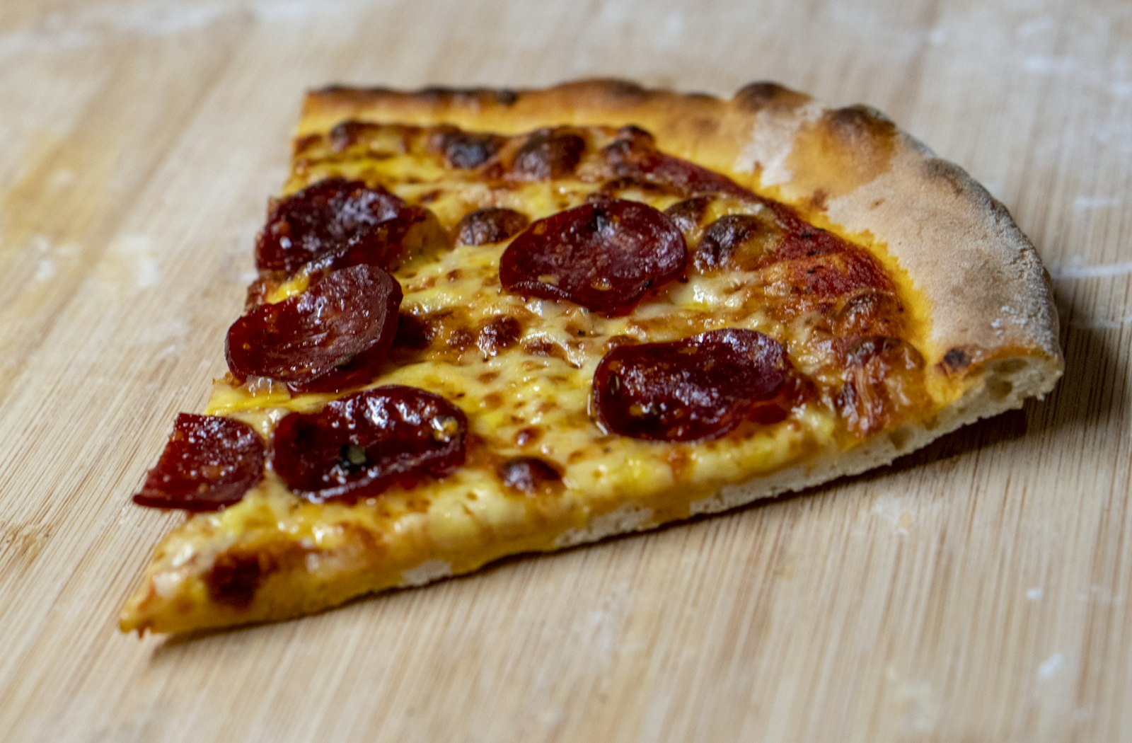 Homemade pepperoni pizza on a board