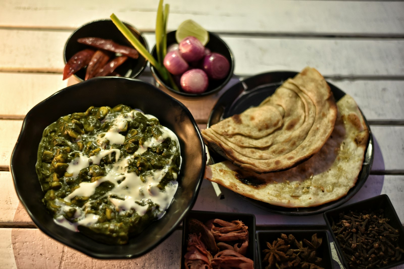 Palak paneer curry with flaky paratha flatbread