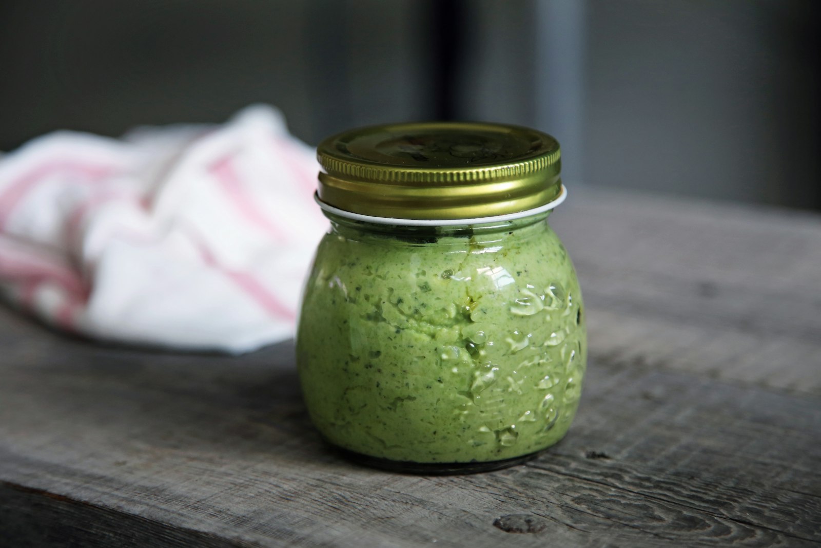 Jar of homemade spinach basil pesto