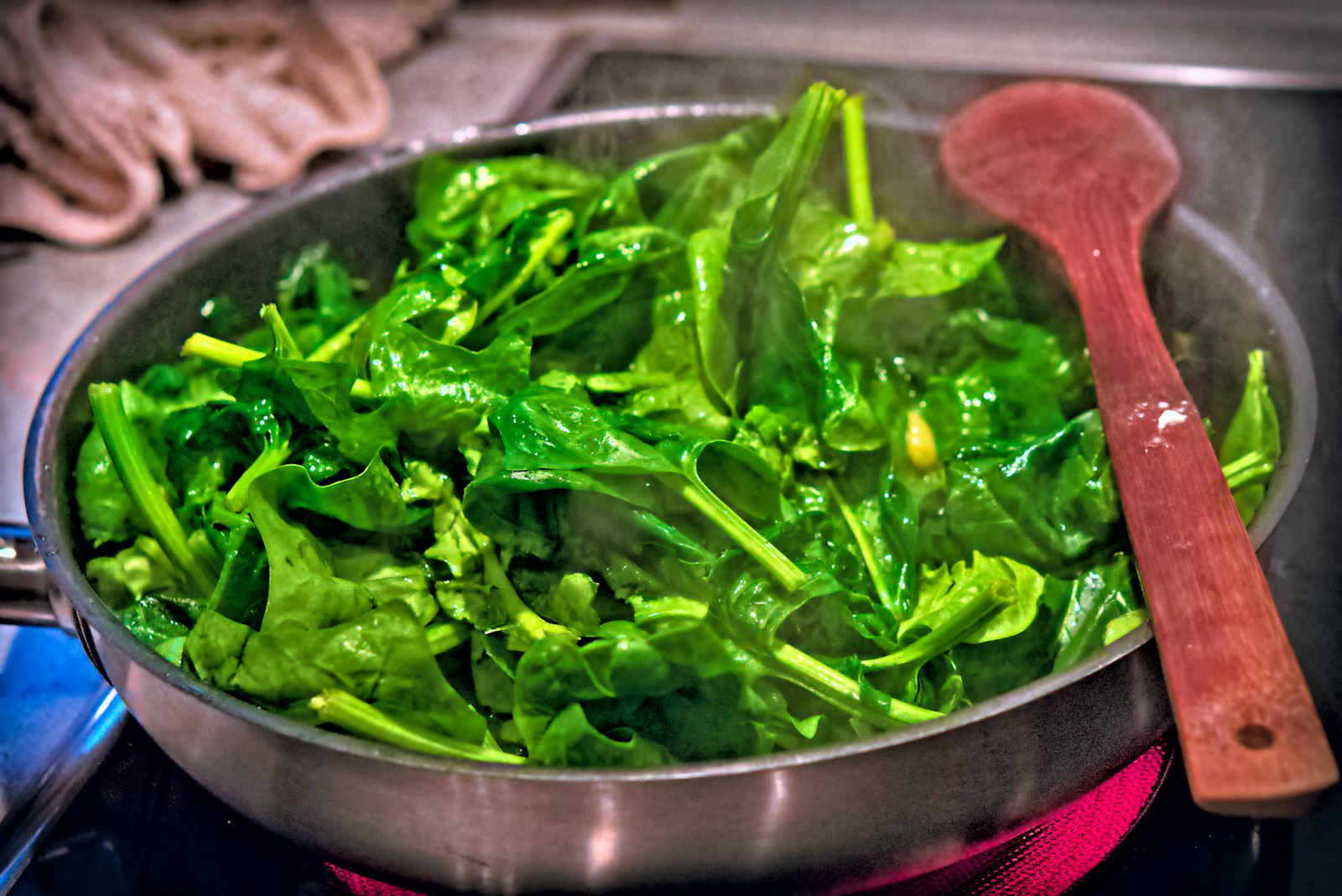 Garlic sauteed spinach in a skillet, one of the fastest leafy greens sides