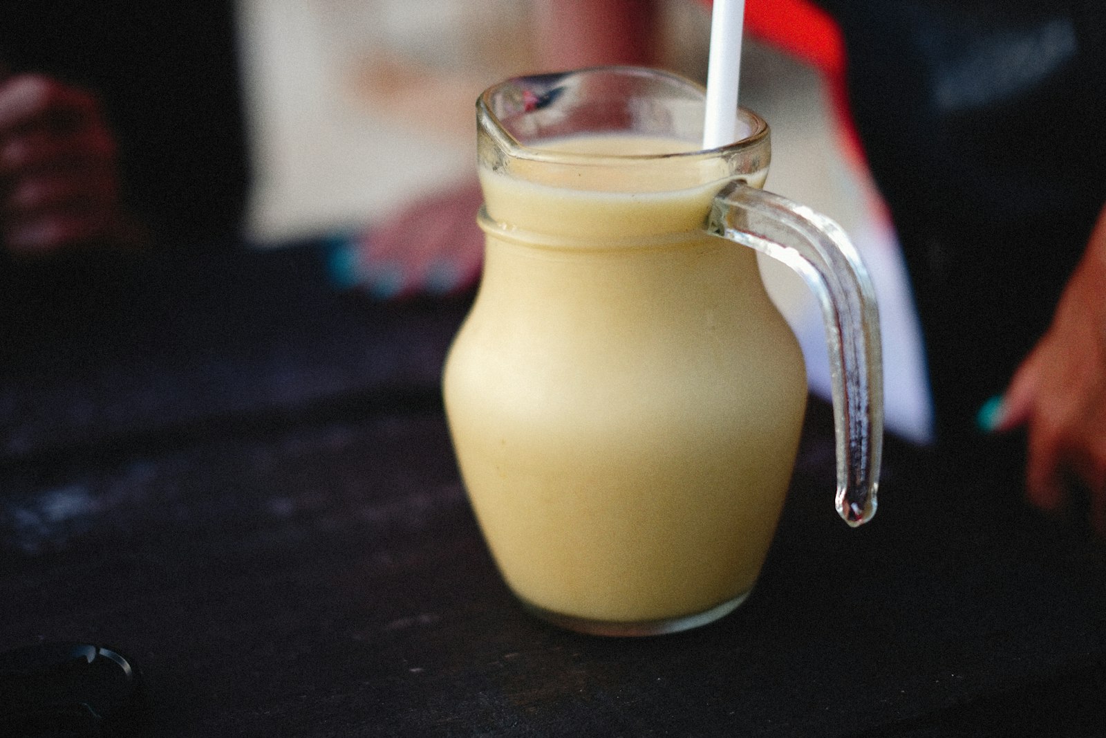 Creamy banana drink in a glass jug