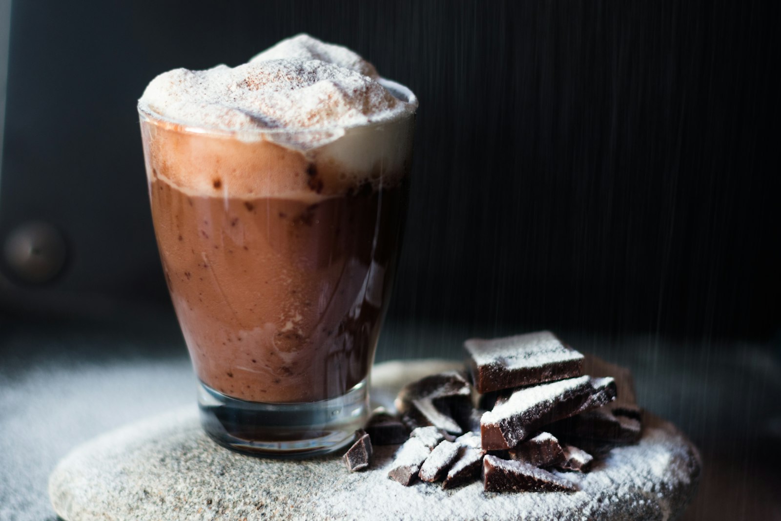 Chocolate oat drink with foam and chocolate pieces