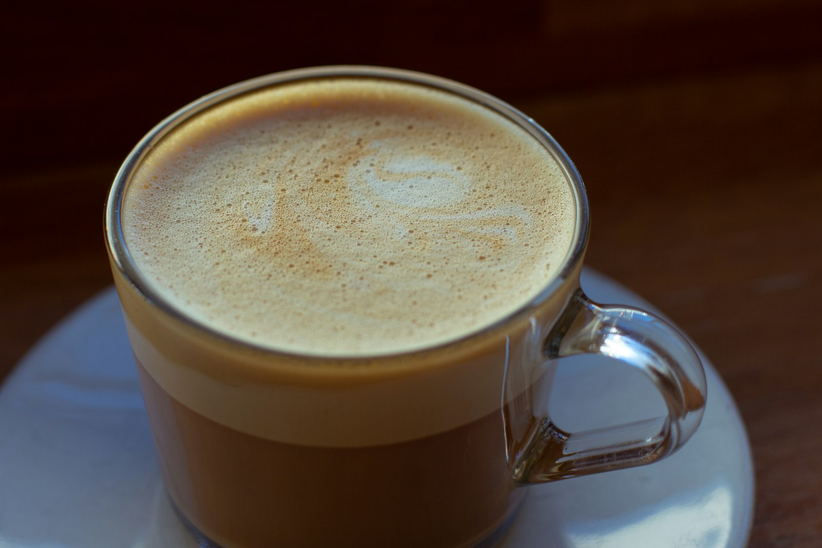 Oat milk latte in a glass cup
