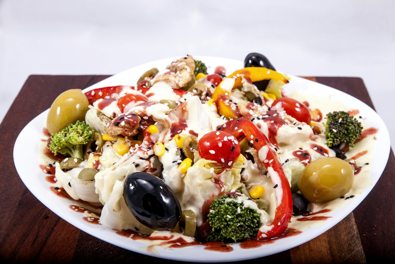 Antipasto style dish with olives, peppers, broccoli and corn