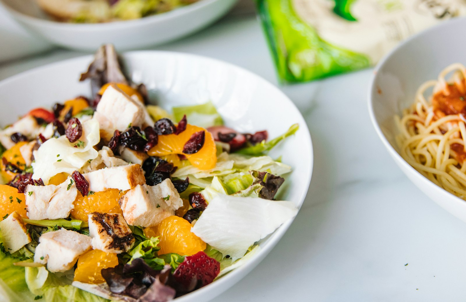 Chicken with oranges, dried cranberries and greens