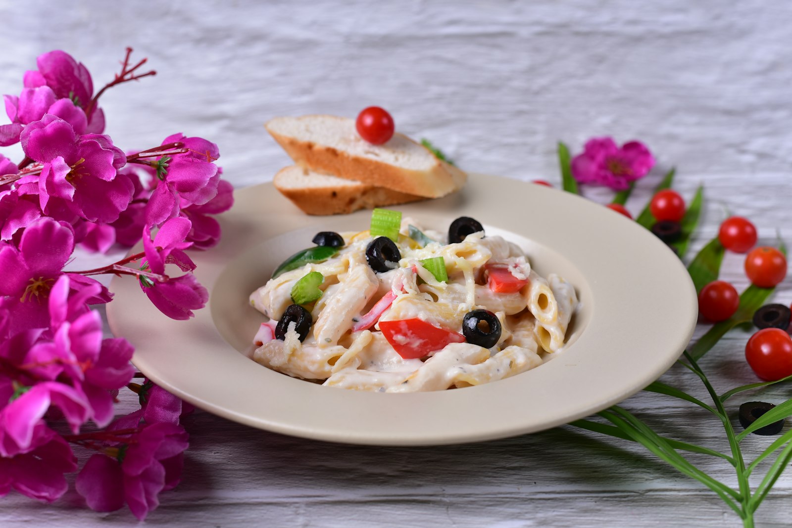 Creamy penne with black olives and cherry tomatoes