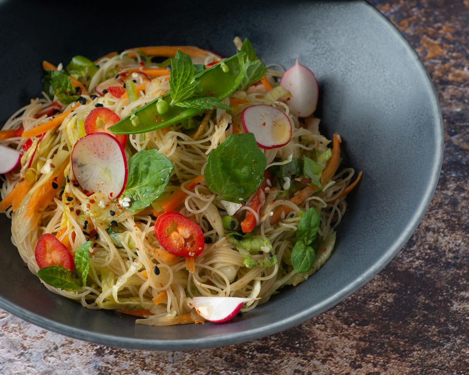 Rice noodles with radish, tomato, carrot and fresh basil