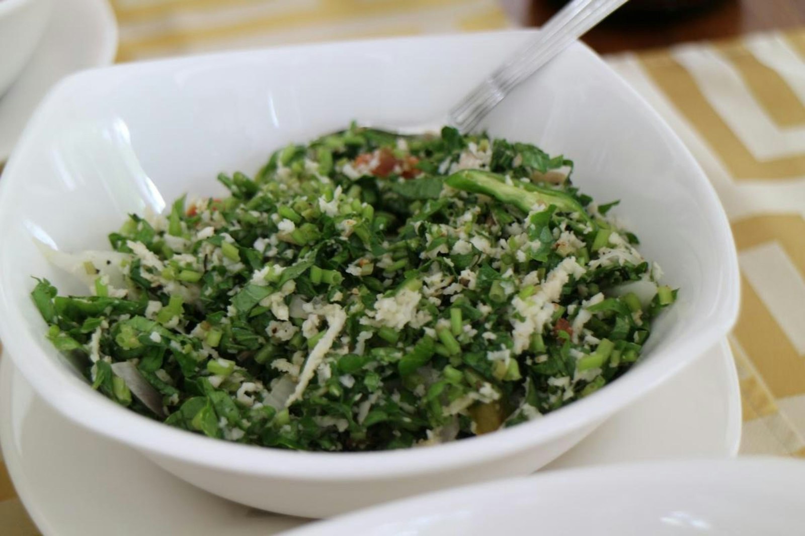 Lemony kale quinoa salad in a white bowl