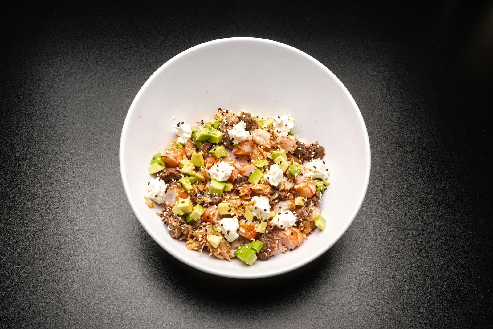 Rainbow chopped quinoa salad in a white bowl