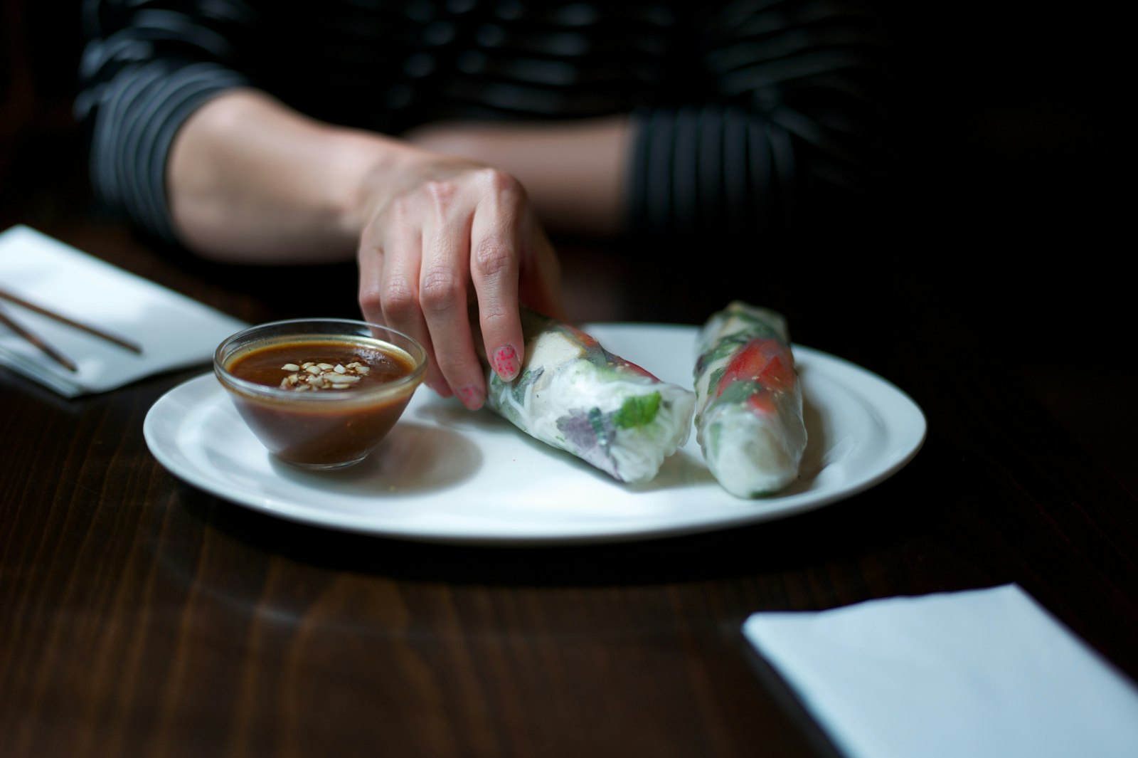 Person dipping a fresh roll into sauce