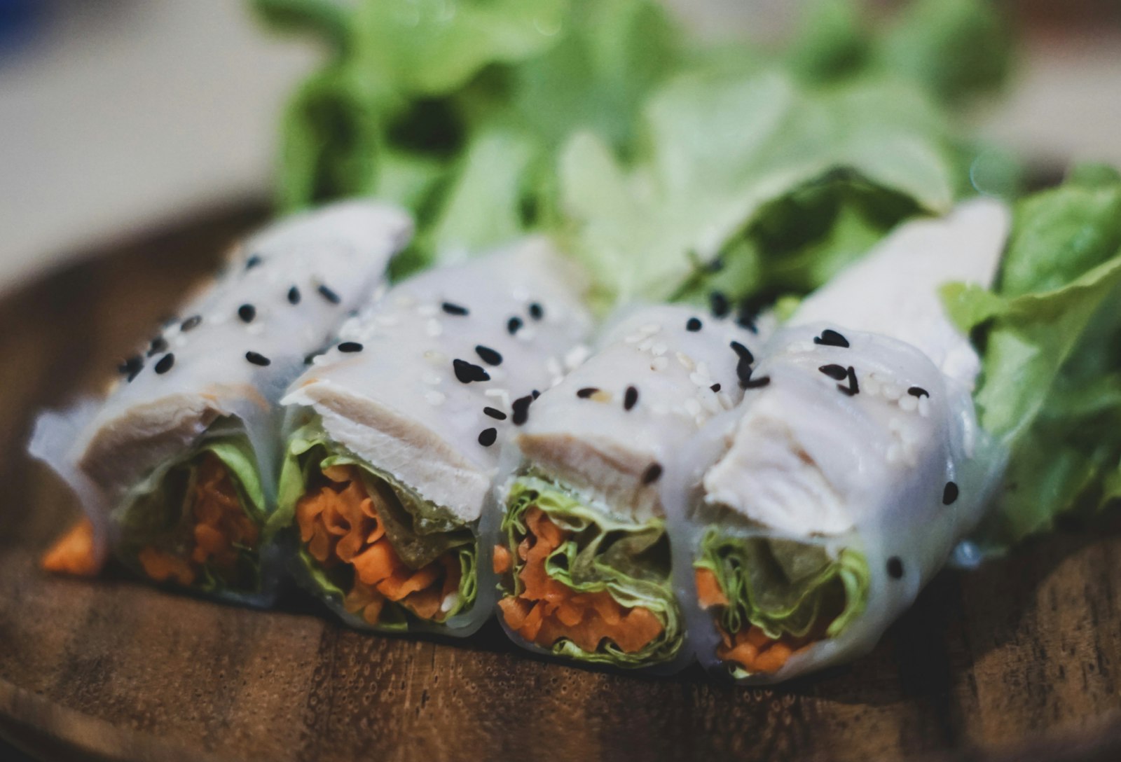Sliced rice paper wraps topped with black sesame seeds