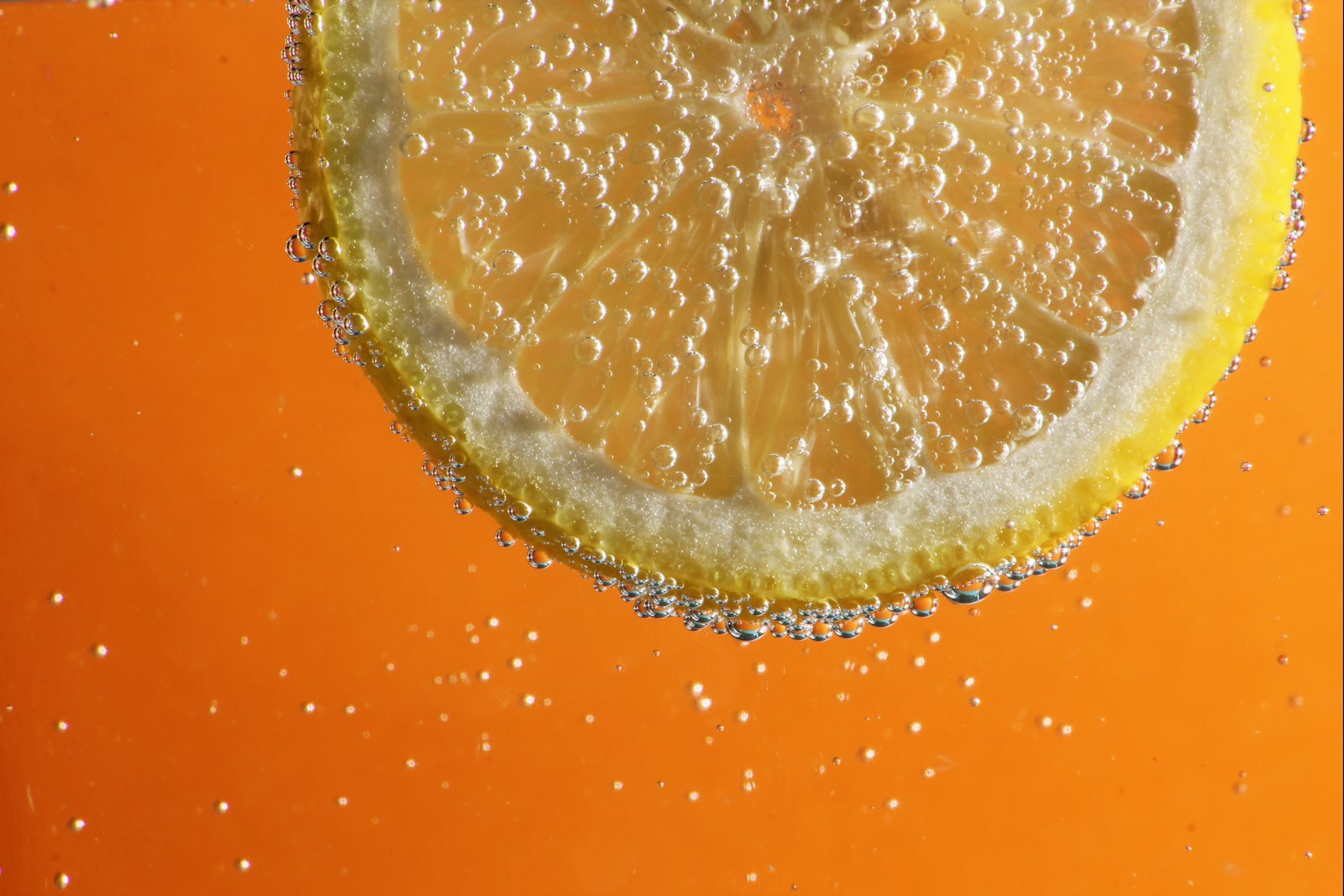 Orange slice floating in sparkling water